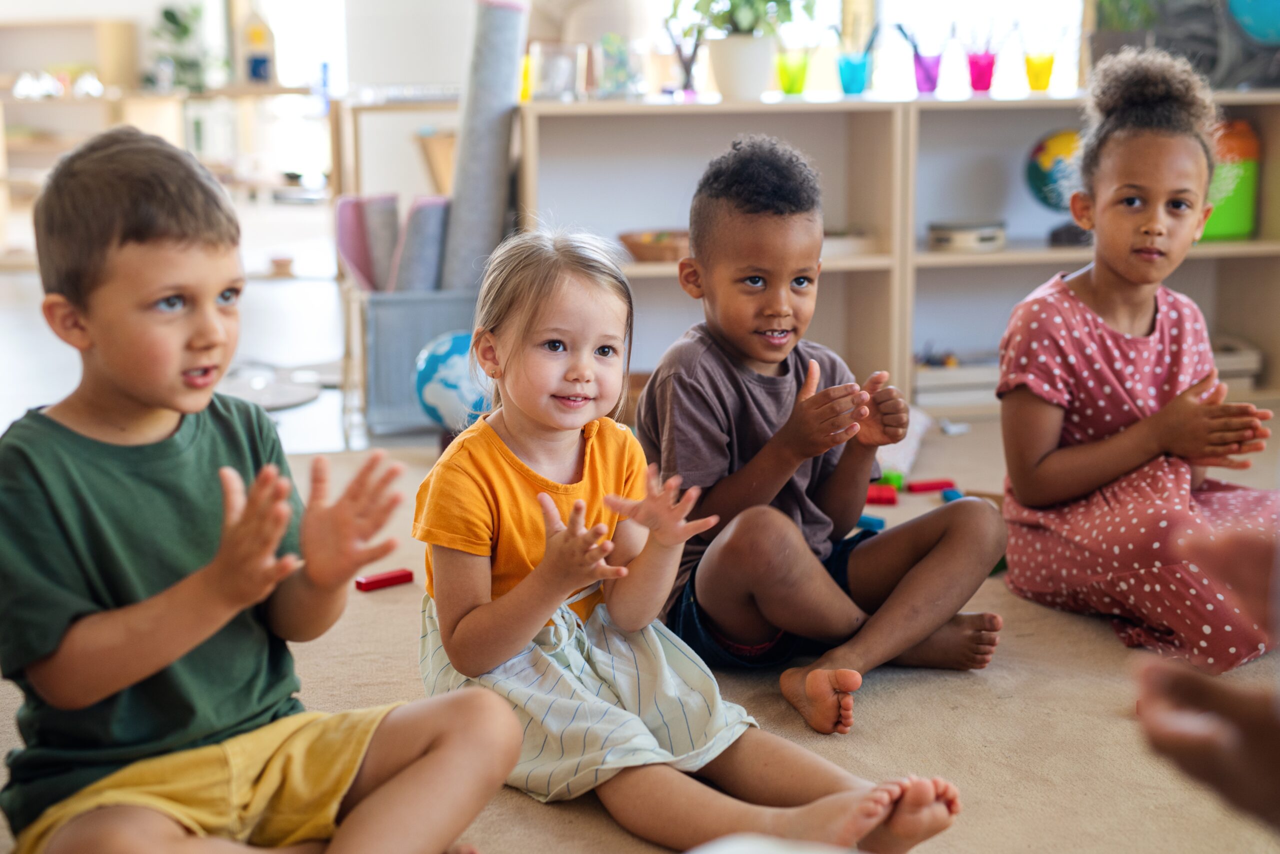 Children sitting in a circle clapping