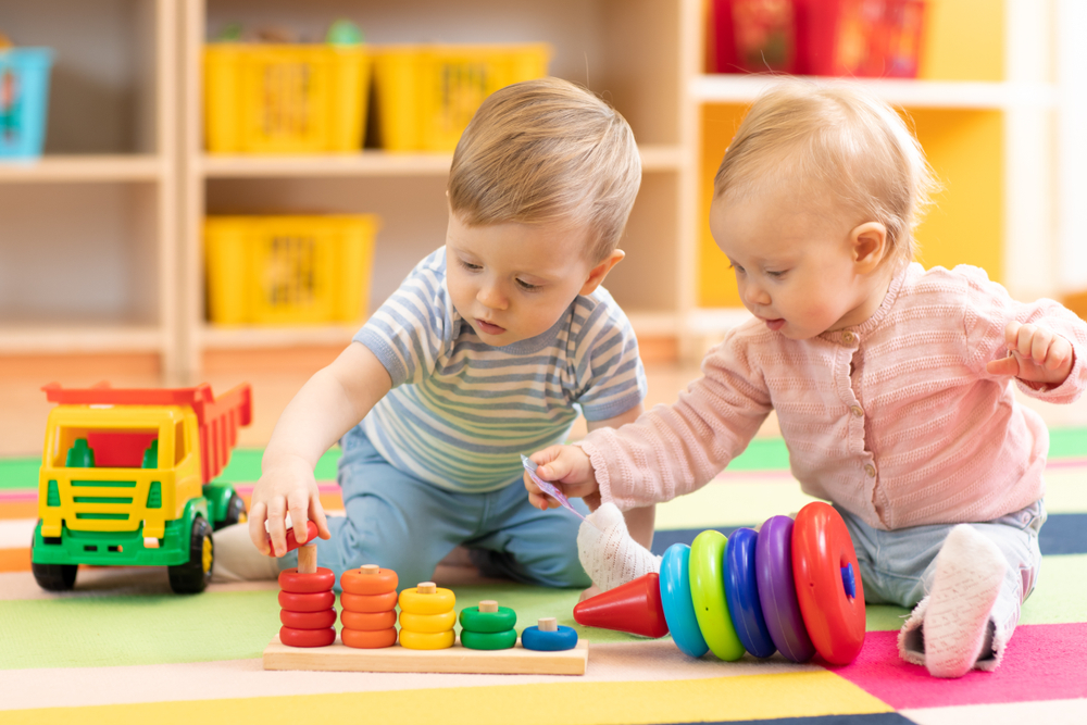 Babies playing with learning activities