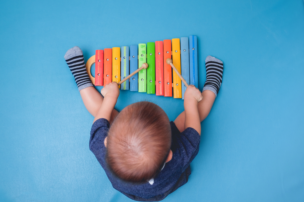 Baby playing musical instrument