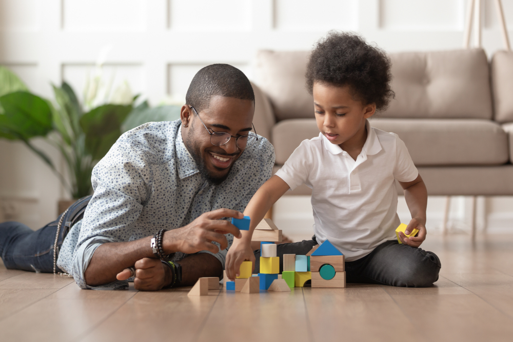 Male teacher helping child